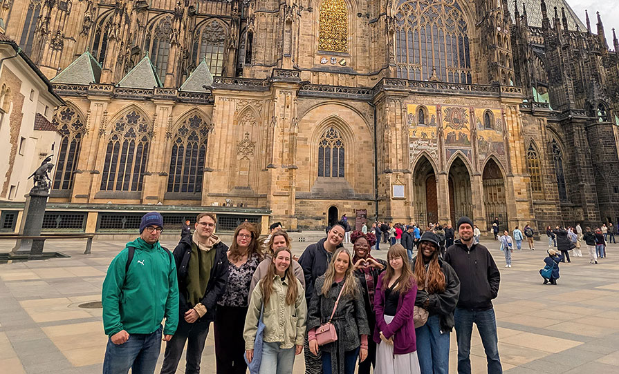 Students from Ohio Wesleyan University and the University of Ostrava in the Czech Republic gather outside of St. Vitus Cathedral in Prague during their collaborative study of 'First-Gen Students and Socioeconomic Transitions.'