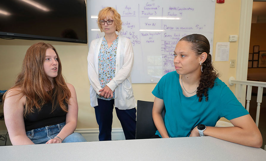 Caroline O’Malley ’28 (from left), Professor Franchesca Nestor, and Hailey Harris ’28 