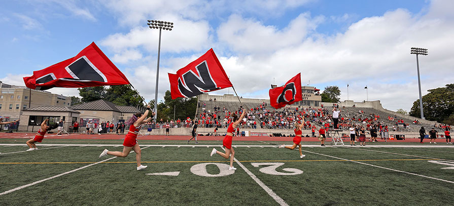 OWU Cheerleaders running across Selby Field